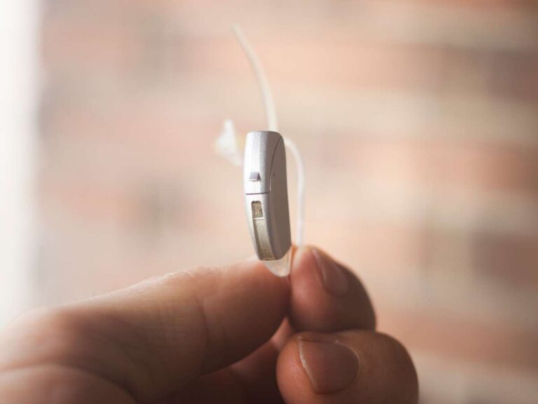 hearing aid held in fingers