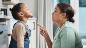 An african american women talking to her child repeating yourself