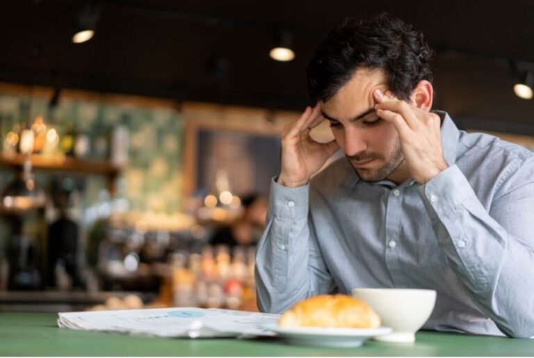 Man with sound sensitivity holding his head